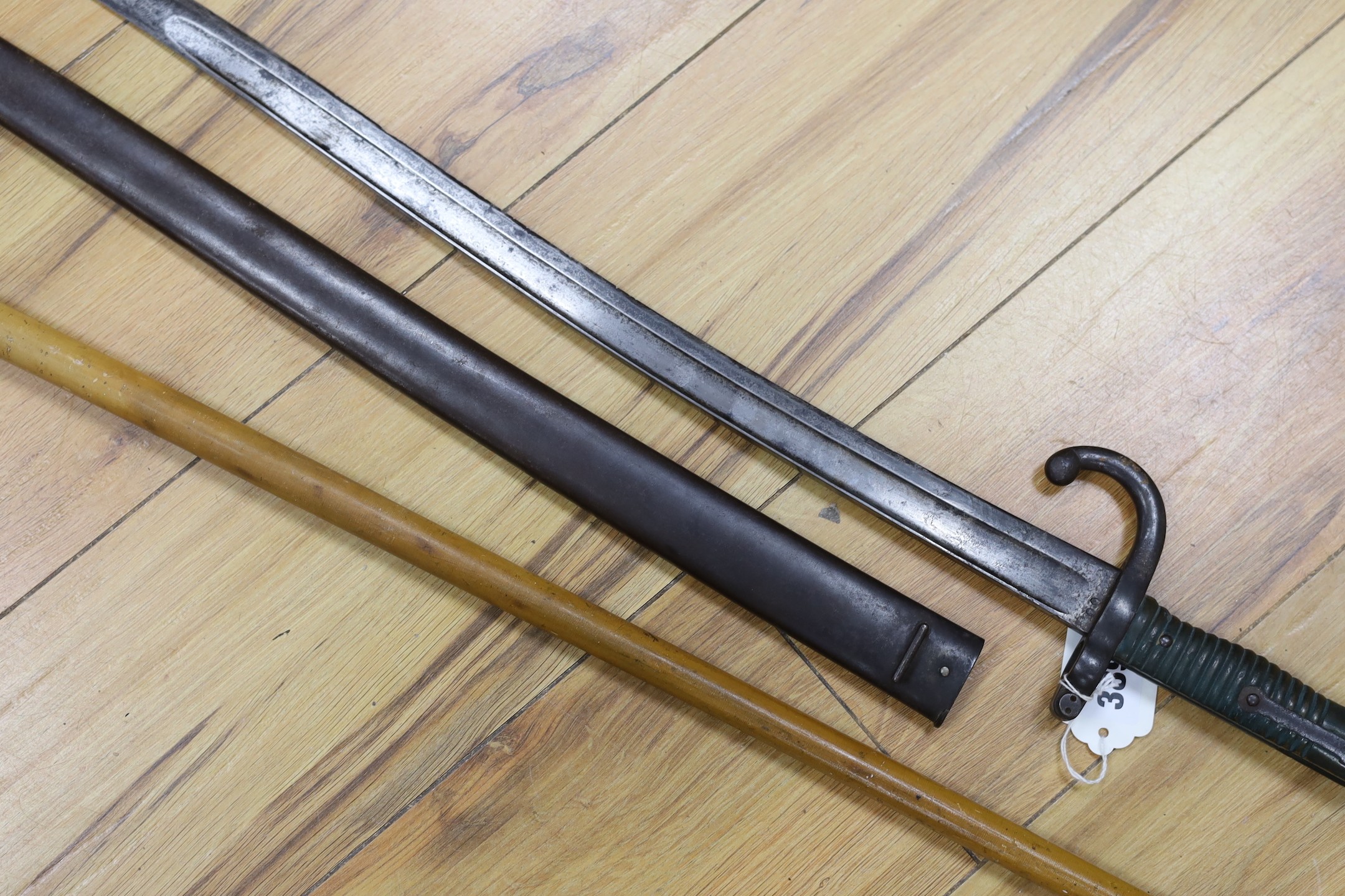 A silver mounted malacca walking cane together with a 19th century French bayonet